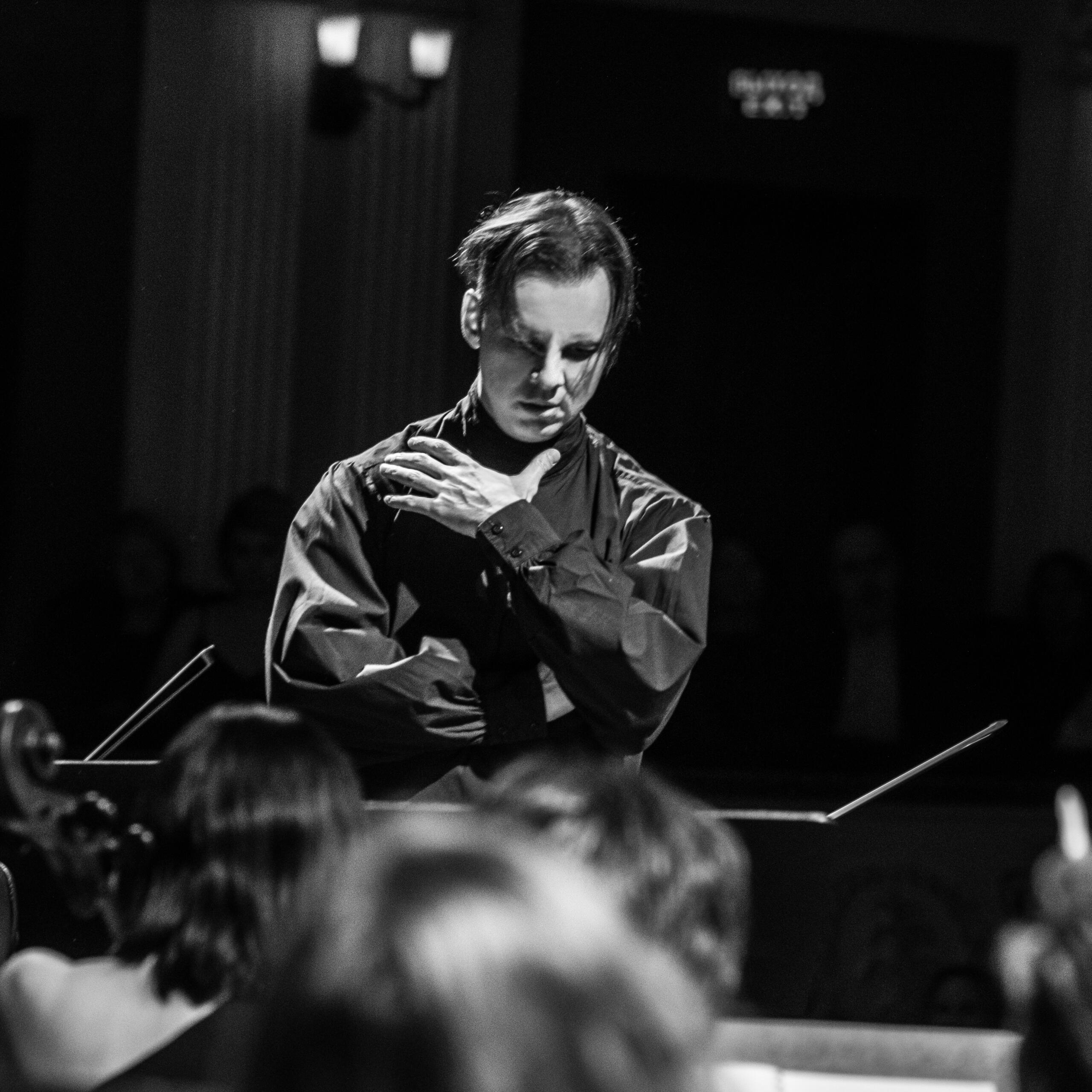 A black-and-white portrait of the conductor Teodor Currentzis.