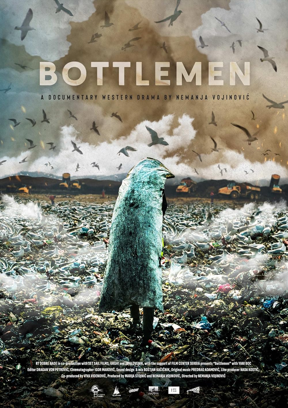 An apocalyptic scene: a figure wrapped in a sack walks across a rubbish dump, seagulls circling overhead.